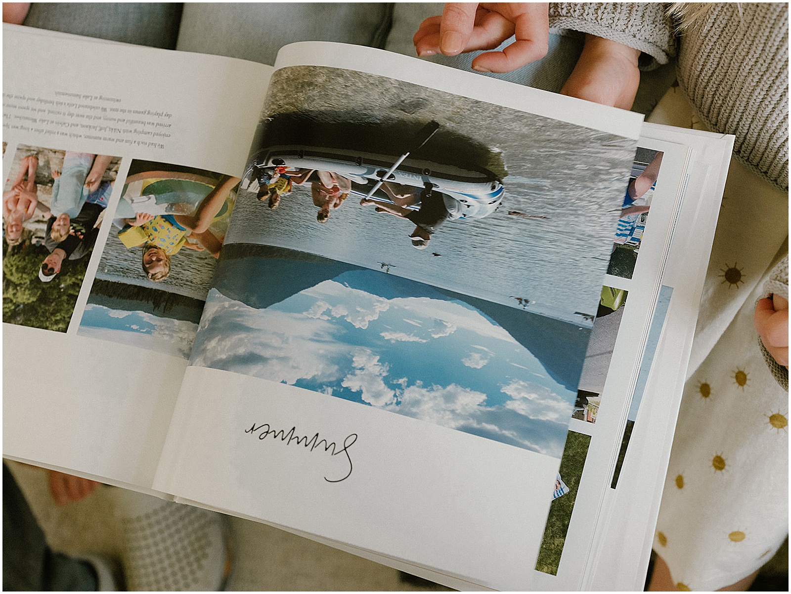 A custom photo album lays open to a photo of a family on a canoe.